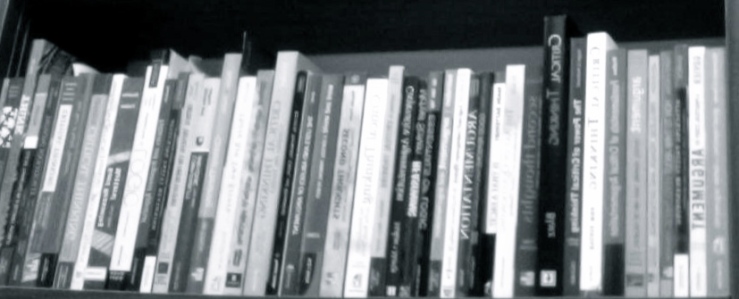 black and white image of critical thinking textbooks packed tightly on a shelf